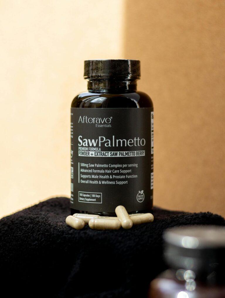 Black bottle of Saw Palmetto supplement on a dark towel with capsules scattered.